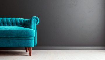 Living room dark grey interior wall mock up with turquoise blue colored velvet sofa, empty grey wall with free space on the right, 3D render, 3D illustration