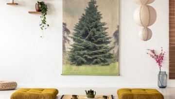 Real photo of two tatami mats with a pot and teacups between in a japanese room interior with big tree painting on a wall