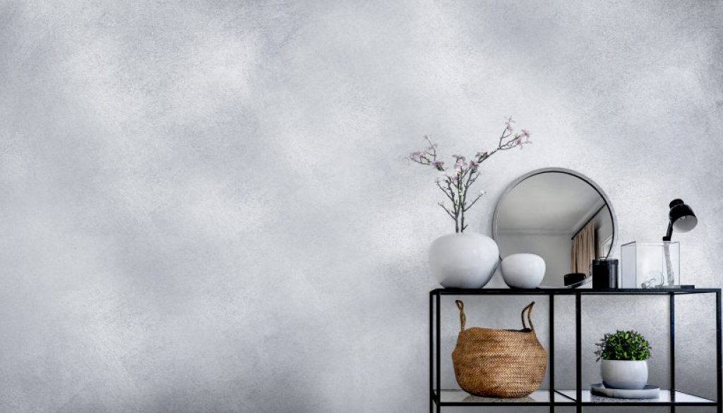 Single modern black display in front of white wall